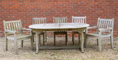 Lot 879 - A teak garden dining table with rounded ends...