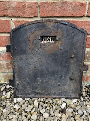 Lot 880 - An old cast iron oven door with strapwork...