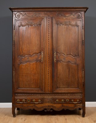 Lot 537 - An antique French armoire, the twin panelled...