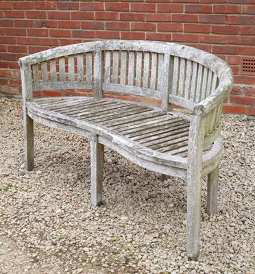 Lot 881 - A garden bench with serpentine front and...