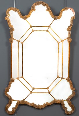 Lot 544 - An antique Venetian wall mirror with shaped...