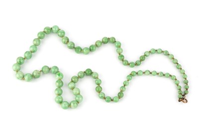 Lot 223 - A jade bead necklace, comprising a single...