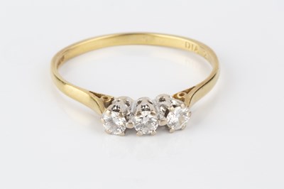 Lot 190 - A diamond three stone ring, the round...