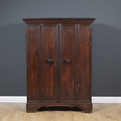 Lot 506 - A continental stained pine cupboard with twin...