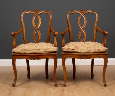 Lot 500 - A pair of continental walnut open armchairs...