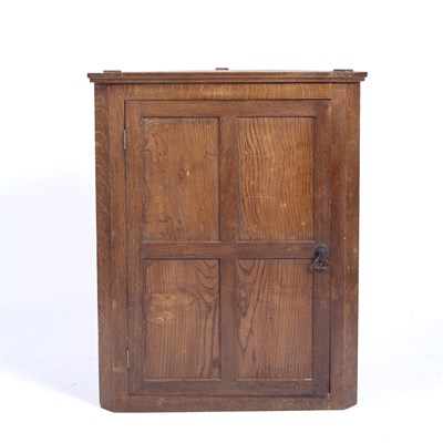 Lot 102 - Cotswold School oak corner cupboard, with...