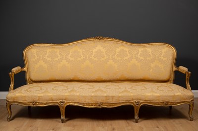 Lot 196 - A large French giltwood sofa, the shaped back...