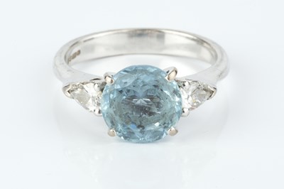 Lot 231 - An aquamarine and diamond three stone ring,...