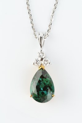 Lot 225 - A green tourmaline and diamond pendant on...