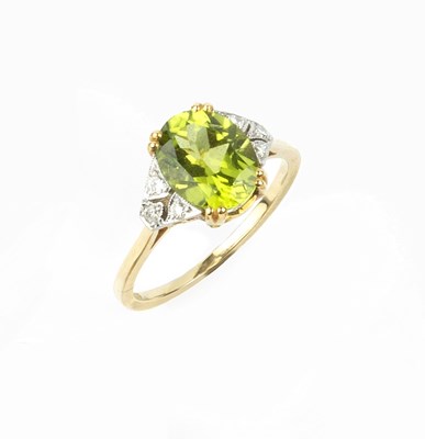 Lot 120 - A peridot and diamond dress ring, the oval...