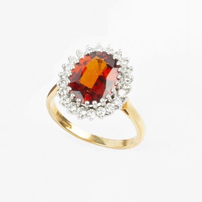 Lot 77 - A garnet and diamond cluster ring, the oval...