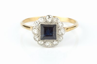 Lot 242 - A sapphire and diamond panel ring, the square...