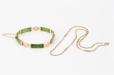 Lot 54 - A green hardstone panel bracelet, the green...