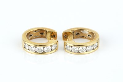 Lot 102 - A pair of diamond set ear hoops, each hinged...