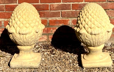 Lot 525 - A pair of cast reconstituted stone pineapple...