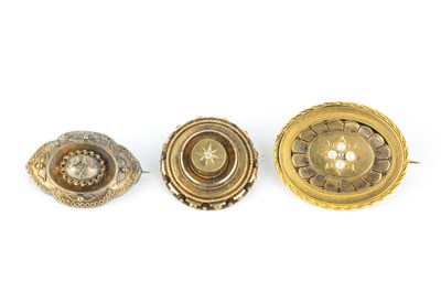 Lot 143 - Three Victorian panel brooches, comprising a...