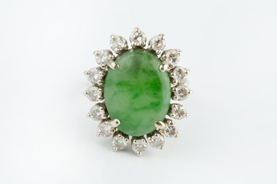 Lot 172 - A jade and diamond cluster ring, the oval...