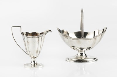 Lot 657 - A late Victorian silver swing handled sugar...