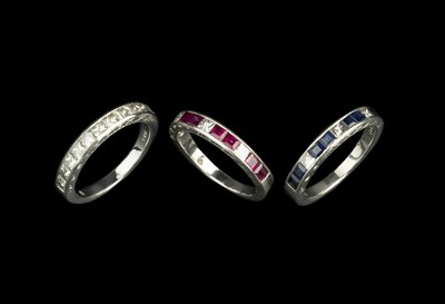 Lot 241 - A set of three diamond set half hoop rings,...