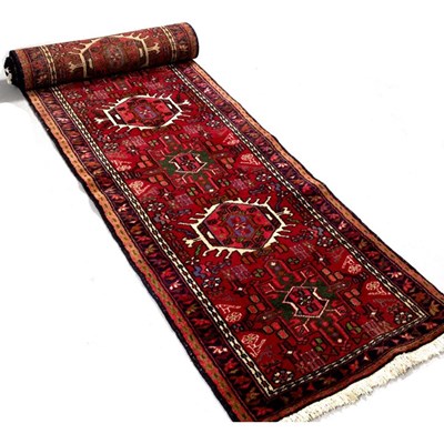 Lot 627 - A Persian Karadja red ground runner, with five...
