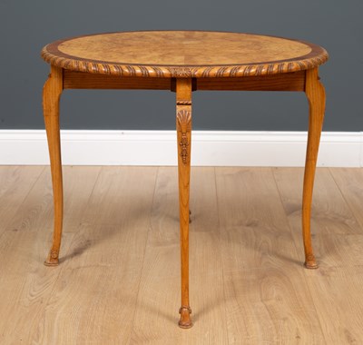 Lot 454 - A circular walnut low occasional table with...