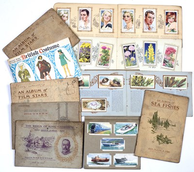 Lot 529 - A collection of fourteen cigarette card albums...