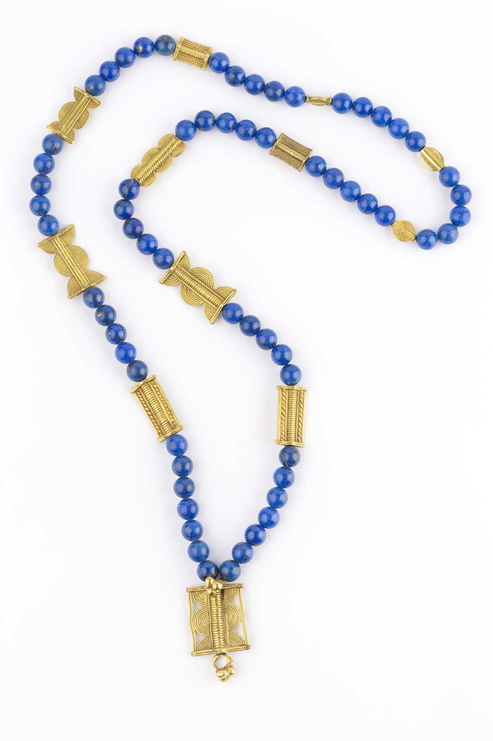 Lot 222 - A lapis lazuli bead necklace, the single...