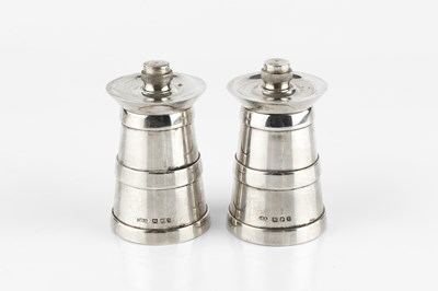 Lot 696 - A pair of silver pepper grinders, modelled as...