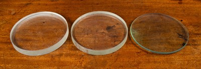 Lot 268 - Three clear glass lenses; two concave, 23cm...
