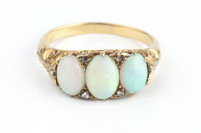 Lot 129 - An opal and diamond half hoop ring, the trio...