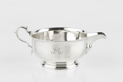 Lot 706 - A silver sauce boat, of circular form, with...