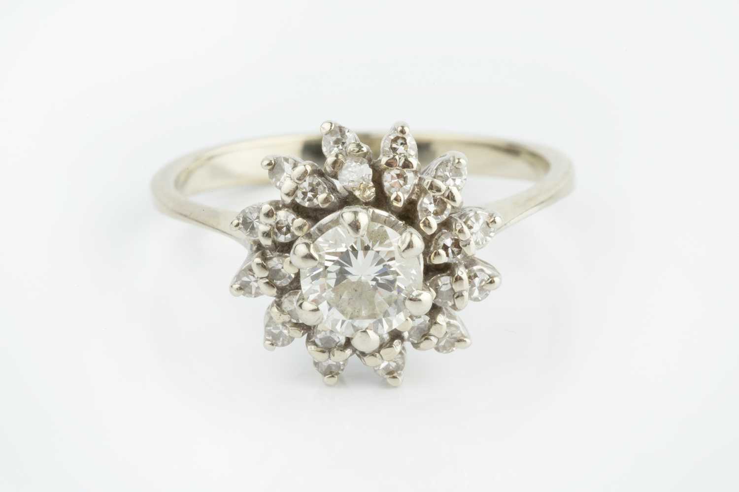 Lot 228 - A diamond cluster ring, the principal round...