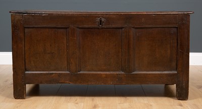 Lot 148 - An 18th century oak chest with three panelled...