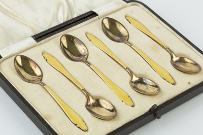 Lot 549 - A set of six silver and yellow enamel tea...