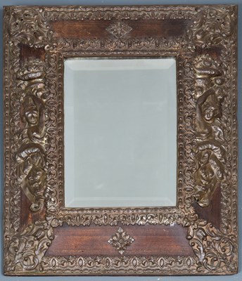 Lot 242 - A repousse bronze wall mirror with beaded edge...