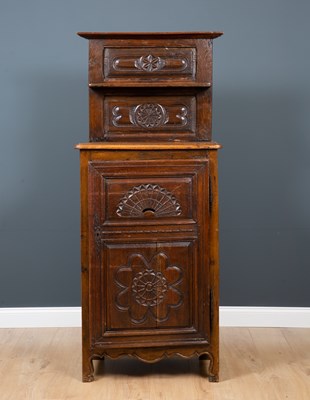 Lot 160 - An 18th century oak bread cupboard with carved...