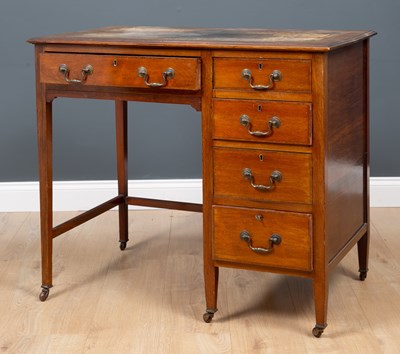 Lot 200 - An Edwardian small desk with leather inset top...