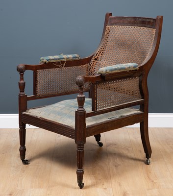 Lot 131 - A bergere armchair with caned back and arm...