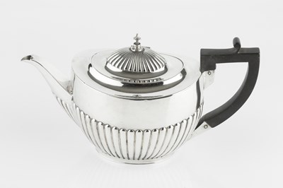 Lot 722 - A late Victorian silver tea pot, of half lobed...