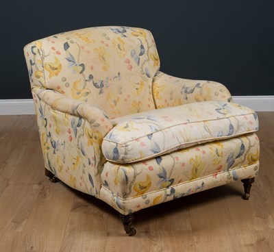 Lot 42 - A Howard style deep armchair standing on...