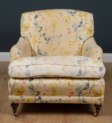 Lot 42 - A Howard style deep armchair standing on...