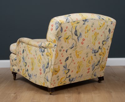 Lot 42 - A Howard style deep armchair standing on...