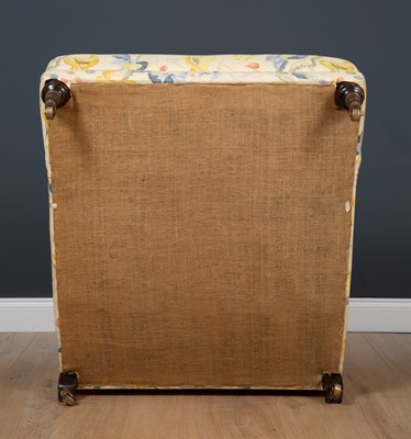 Lot 42 - A Howard style deep armchair standing on...