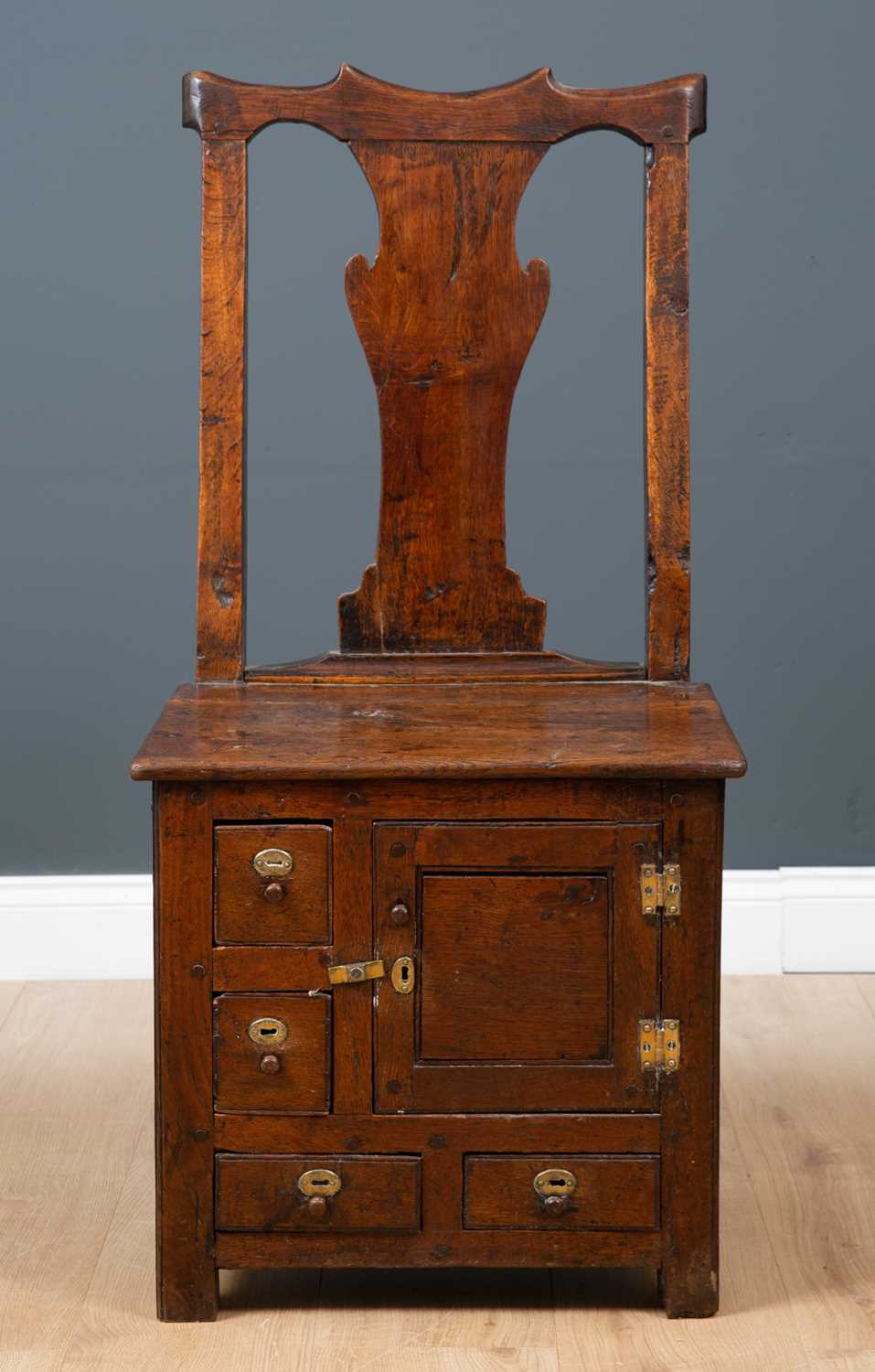 Lot 45 - A George III Irish oak country chair possibly...
