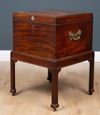 Lot 41 - A George III mahogany cellarette with lion...