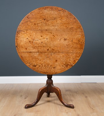 Lot 29 - A George III oak circular tilt top tripod...