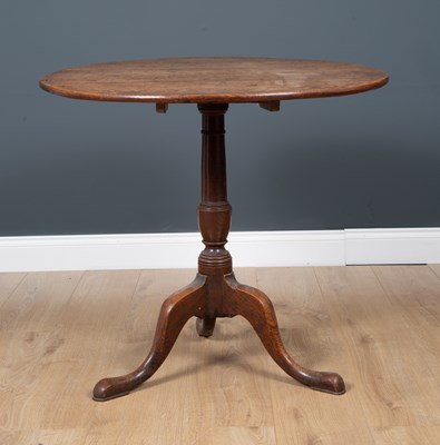 Lot 29 - A George III oak circular tilt top tripod...