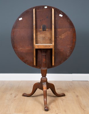 Lot 29 - A George III oak circular tilt top tripod...