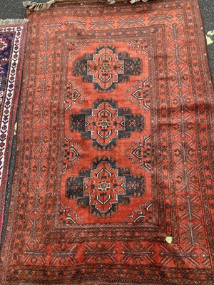 Lot 626 - A Belouchi style red ground rug 200cm x 124cm...