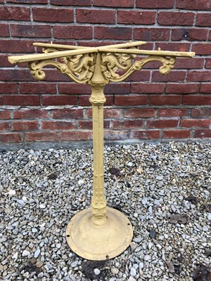 Lot 534 - A yellow painted cast iron table base with...